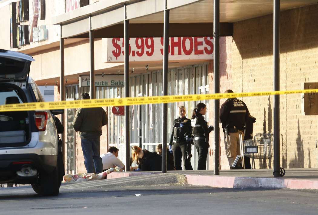 Las Vegas police have blocked off part of the parking lot in front of the Rancho Discount Mall near Rancho Drive and Washington Avenue as they investigate a deadly shooting, Monday, Jan. 29, 2018, ...