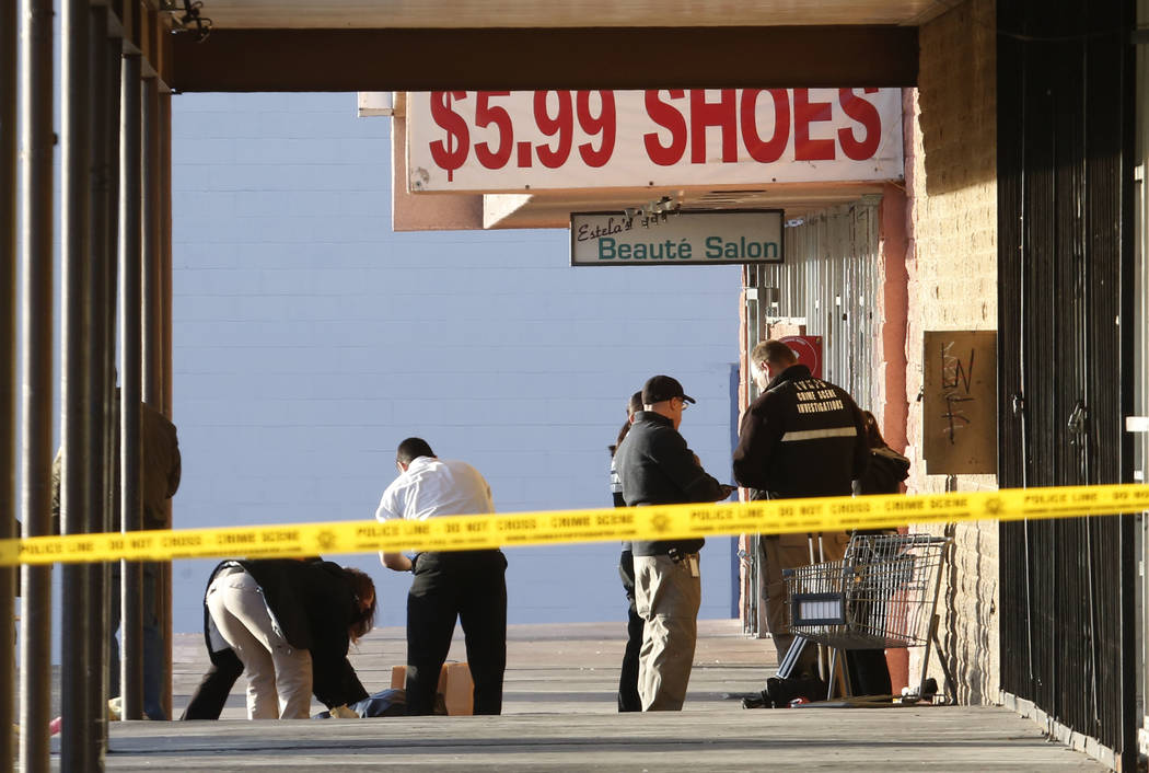 Las Vegas police have blocked off part of the parking lot in front of the Rancho Discount Mall near near Rancho Drive and Washington Avenue as they investigate a deadly shooting, Monday, Jan. 29,  ...