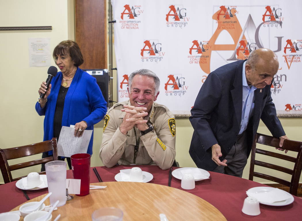 Rita Vaswani, president of the Asian American Group, introduces Clark County Sheriff Joe Lombardo while AAG Chairman Mike Vaswani takes a seat during a dinner event with the Asian American communi ...