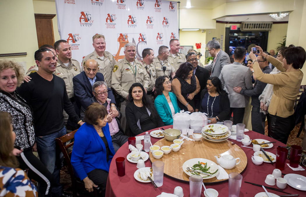 Members of the Asian American community have their photo taken with Metropolitan Police Department captains at the Hong Kong Garden Seafood & Dim Sum Cafe on Spring Mountain Road in Las Vegas  ...