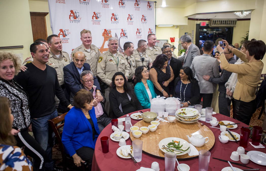 Members of the Asian American community have their photo taken with Metropolitan Police Department captains at the Hong Kong Garden Seafood & Dim Sum Cafe on Spring Mountain Road in Las Vegas ...