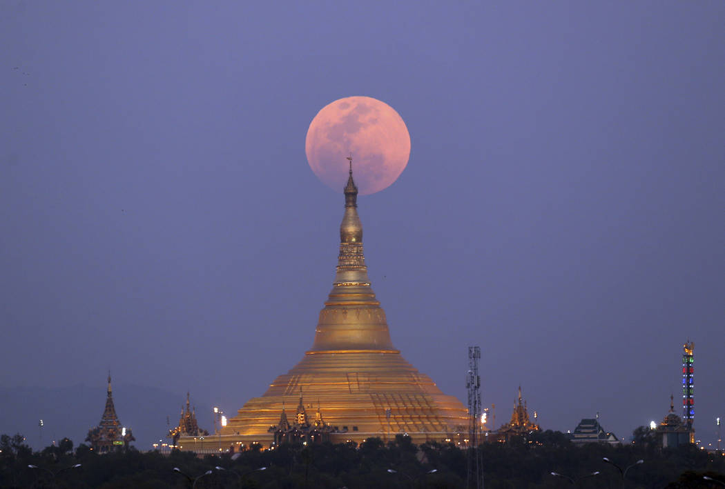 The moon rises behind the Uppatasanti Pagoda seen from Naypyitaw, Myanmar, Wednesday, Jan. 31, 2018. (AP Photo/Aung Shine Oo)