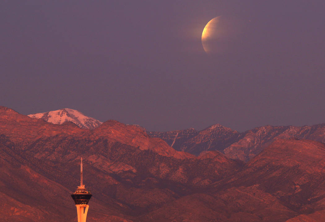 The Stratosphere tower is seen in the foreground as a partially eclipsed super blue blood moon  sets behind Mount Charleston, Wednesday, Jan. 31, 2018 in Las Vegas. David Guzman Las Vegas Review-J ...