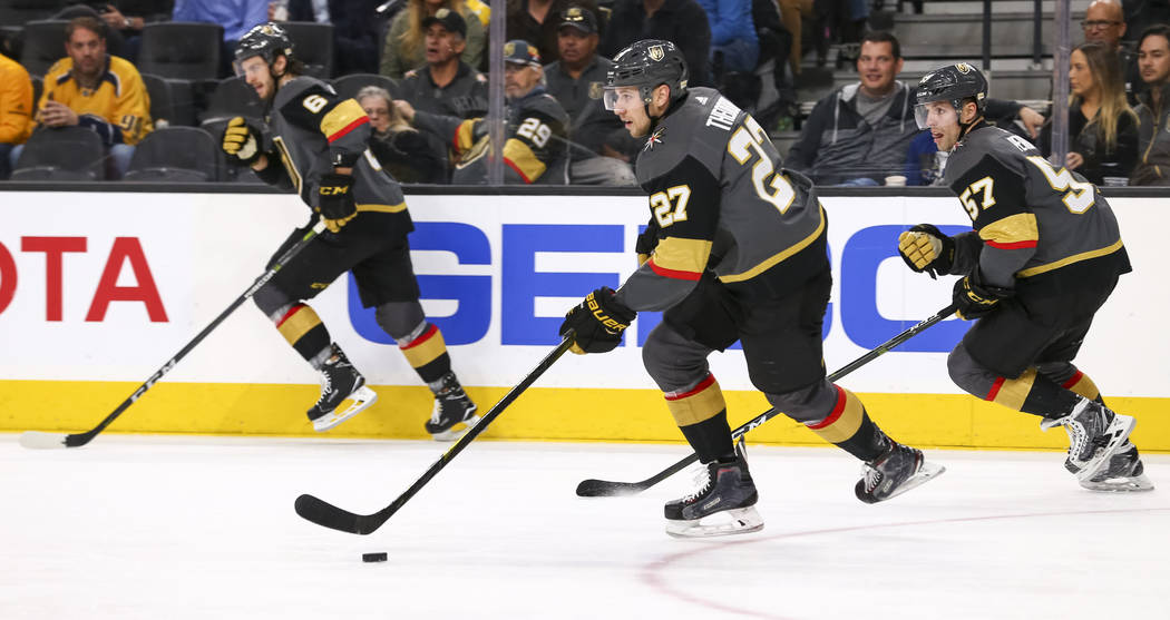 Vegas Golden Knights' Colin Miller, from left, Shea Theodore (27) and David Perron (57) on the attack during the second period of an NHL hockey game against the Nashville Predators at the T-Mobile ...