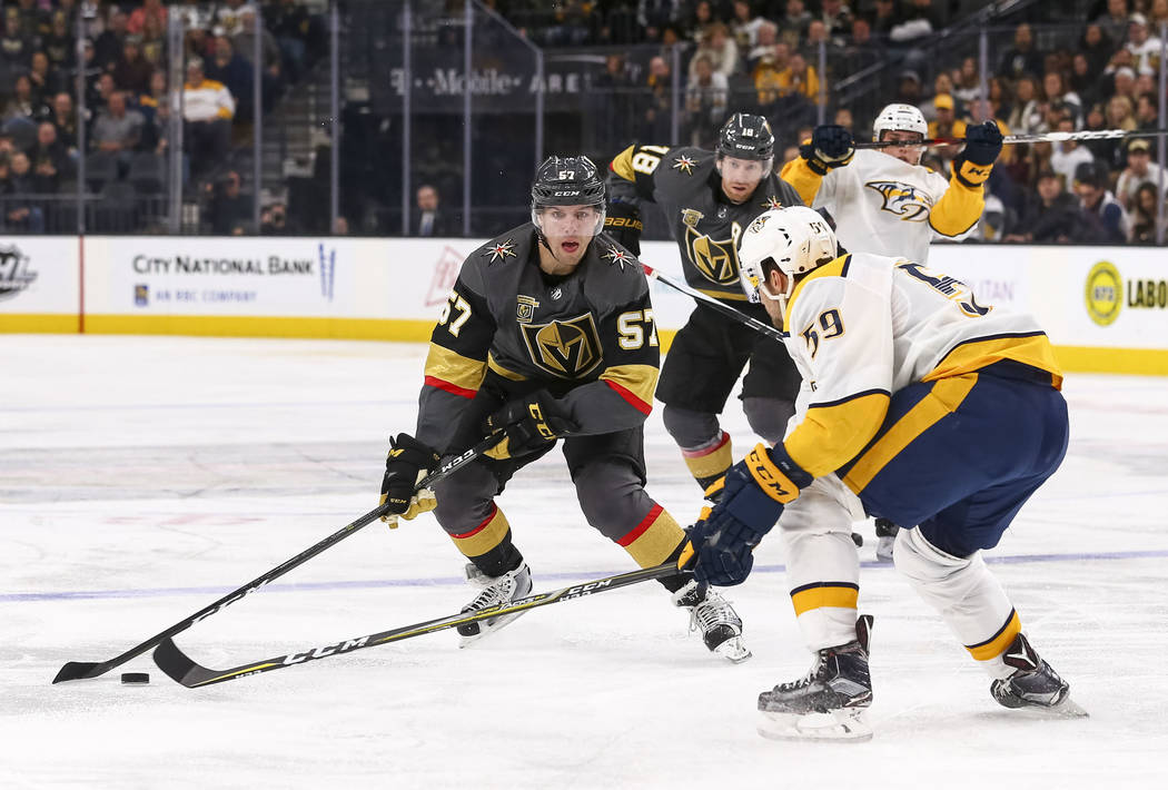 Vegas Golden Knights left wing David Perron (57) controls the puck against Nashville Predators defenseman Roman Josi (59) during the third period of an NHL hockey game between the Vegas Golden Kni ...
