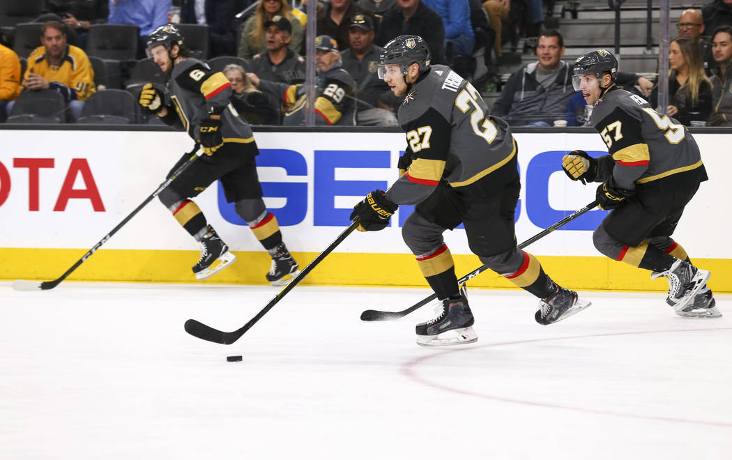 Vegas Golden Knights' Colin Miller, from left, Shea Theodore (27) and David Perron (57) on the attack during the second period of an NHL hockey game against the Nashville Predators at the T-Mobile ...