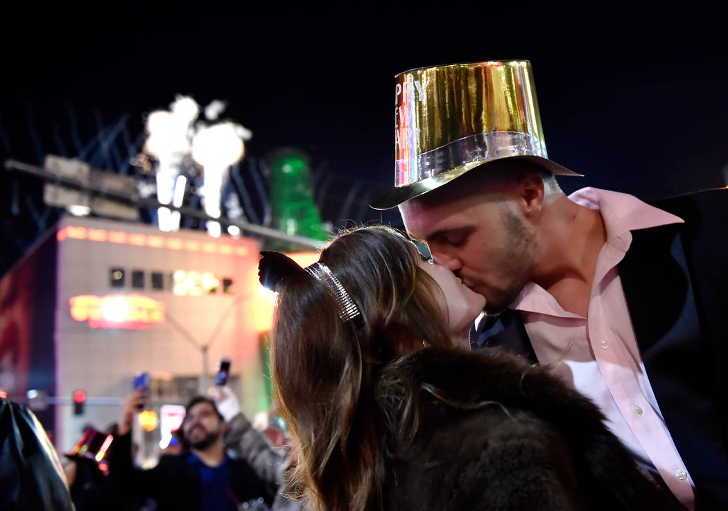 Breanna Vereeke and Graham Gugino of Mich. kiss as they bring in the new year along the Las Vegas Strip Monday, Jan. 1, 2018, in Las Vegas. David Becker/Las Vegas News Bureau