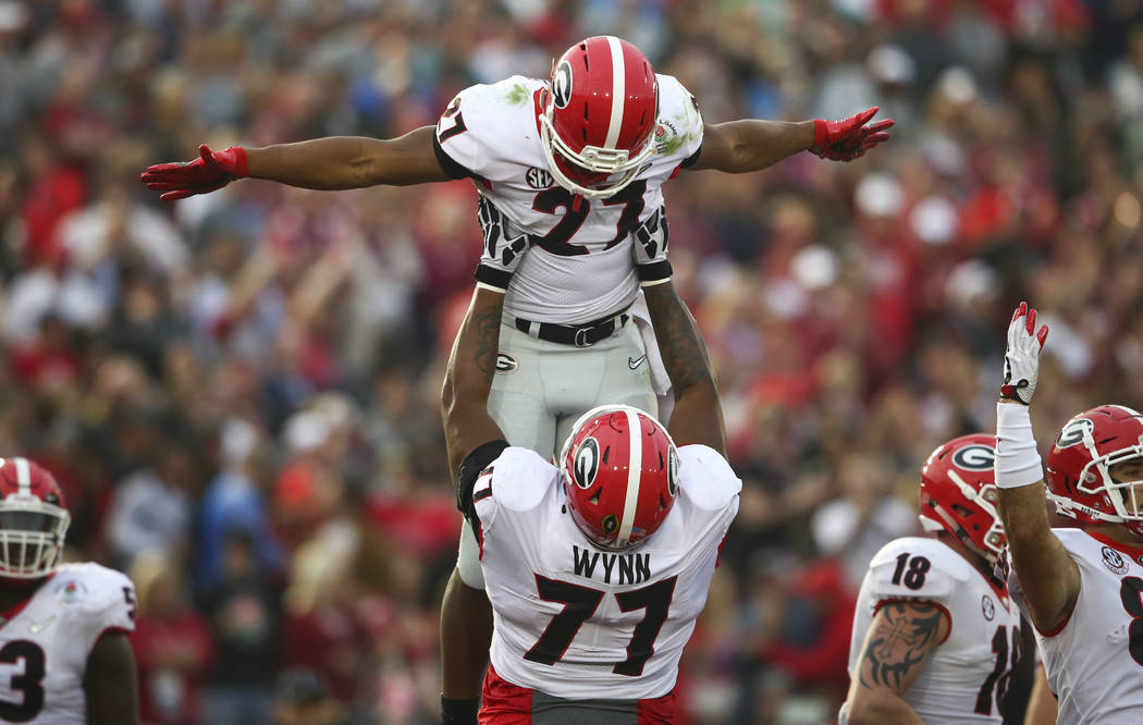 Georgia Bulldogs running back Nick Chubb (27) celebrates his touchdown with  Georgia Bulldogs offensive tackle Isaiah Wynn (77) during the second half  of the College Football Playoff semifinal agai …