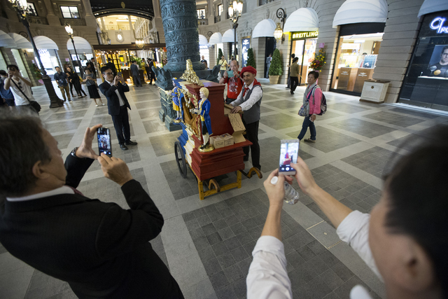 People photograph a music player inside the Parisian Macao hotel-casino on Wednesday, Sept. 14, 2016, in Macau. Erik Verduzco/Las Vegas Review-Journal Follow @Erik_Verduzco