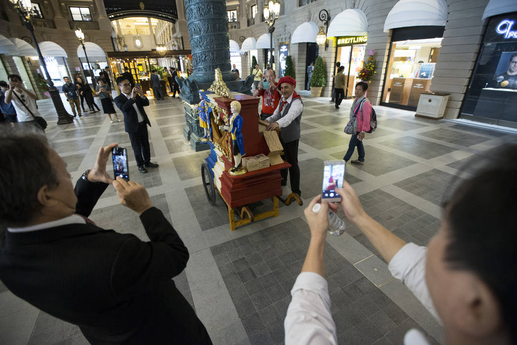 People photograph a music player inside the Parisian Macao hotel-casino on Wednesday, Sept. 14, 2016, in Macau. Erik Verduzco/Las Vegas Review-Journal Follow @Erik_Verduzco