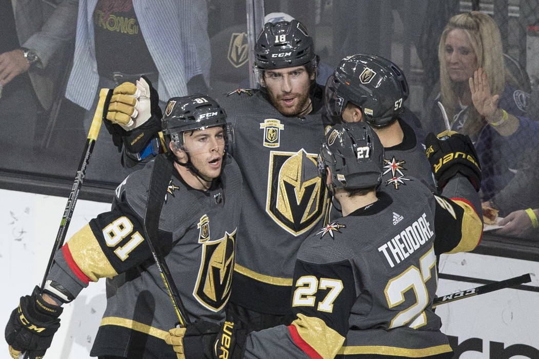 Golden Knights left wing James Neal (18) celebrates with center Jonathan Marchessault (81) and Shea Theodore (27) after scoring a second period goal during Vegas' home matchup with the Lighting on ...