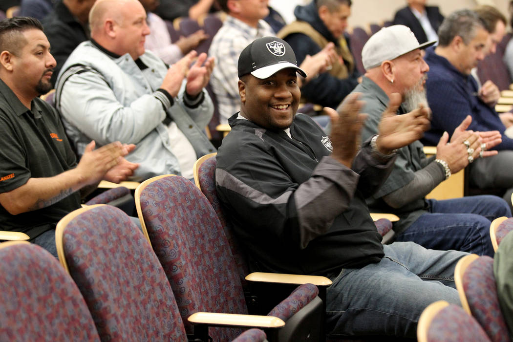 Raiders fans, including Ken McLin, center, applaud after the Henderson City Council voted to to sell 55 acres to the NFL team for half the landճ appraised value Tuesday, Jan. 2, 2018. K.M. C ...