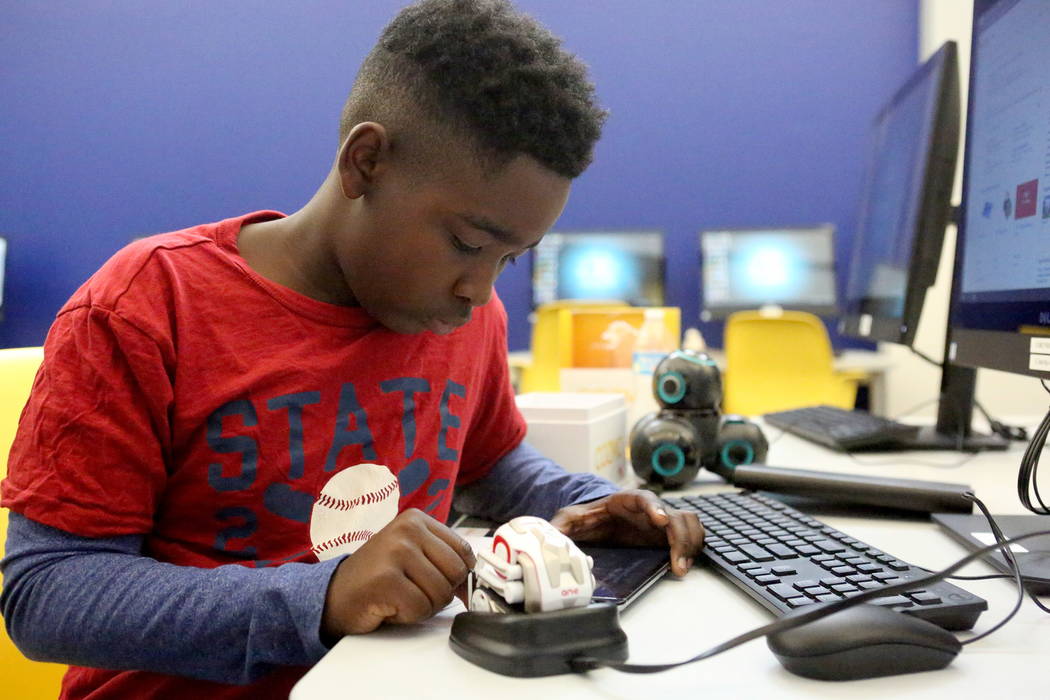 Frank Williamson, 13, learns how to program a small robot at the Clark County Library’s Teen Tech Center which gives kids access to high-tech electronics and other materials with a science/ ...