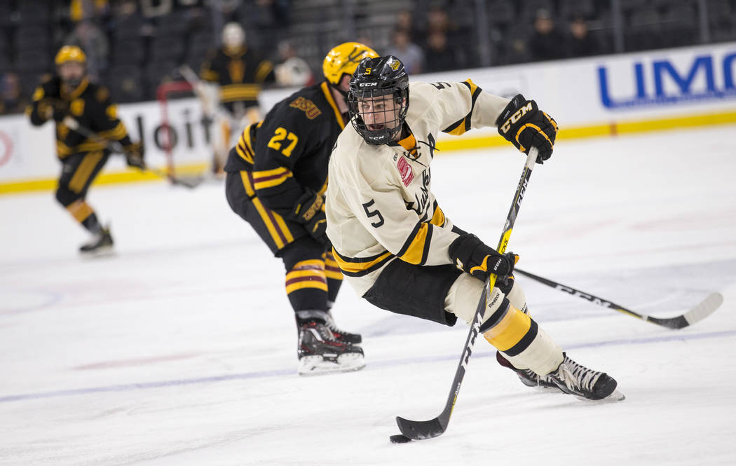Michigan Tech Huskies defenseman Mitch Reinke (5) controls the puck against Arizona State Sun Devils during the inaugural Ice Vegas Invitational college hockey tournament at T-Mobile Arena in Las  ...