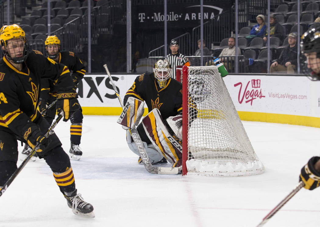 Arizona State Sun Devils goaltender Joey Daccord (35) keeps an eye on the puck against the Michigan Tech Huskies during the inaugural Ice Vegas Invitational college hockey tournament at T-Mobile A ...