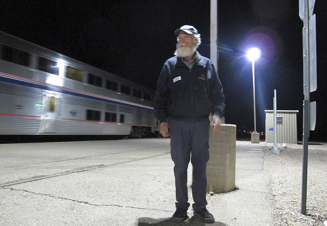 In this Friday, Dec. 29, 2017 photo, Len Daley waits for the last passengers from an Amtrak train at Williams Junction to board shuttles to nearby Williams, Ariz. Shuttle service between the junct ...