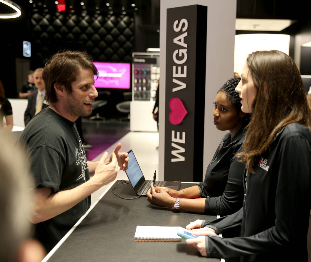 The T-Mobile employees Fatou Niang, center, and Kelly Fisher, talk to Jonathan Finkel on opening night Thursday, Jan. 4, 2018. It is located inside the Showcase Mall, near the intersection of Las  ...
