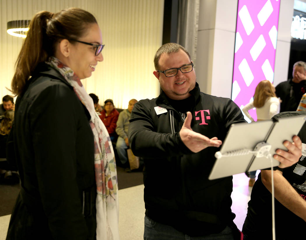 T-Mobile Signature Mobile Expert Shane Butts helps Jessica Spear of Brazil on opening night of the Strip store Thursday, Jan. 4, 2018. It is located inside the Showcase Mall, near the intersection ...
