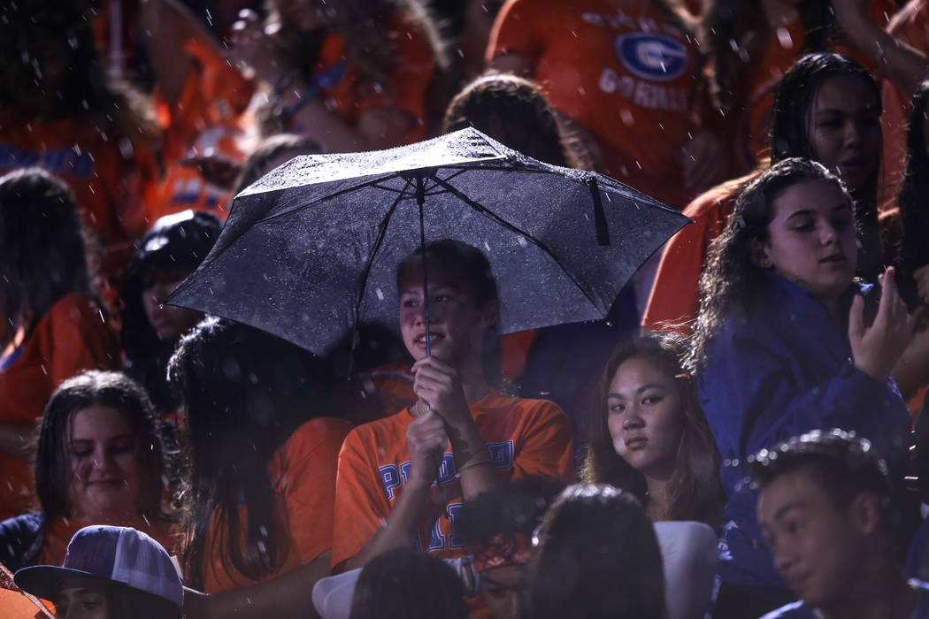 Fans sit in the rain during a delay at the Bishop Gorman versus Miami Central football game at Bishop Gorman High School in Las Vegas, Friday, Sept. 8, 2017. Joel Angel Juarez Las Vegas Review-Jou ...