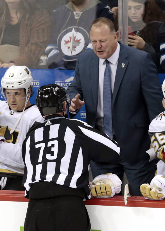 Dec 1, 2017; Winnipeg, Manitoba, CAN;  Vegas Golden Knights Head Coach Gerard Gallant talks with Linesman Vaughan Rudy during a stop in play in the first period at Bell MTS Place. (James Carey Lau ...