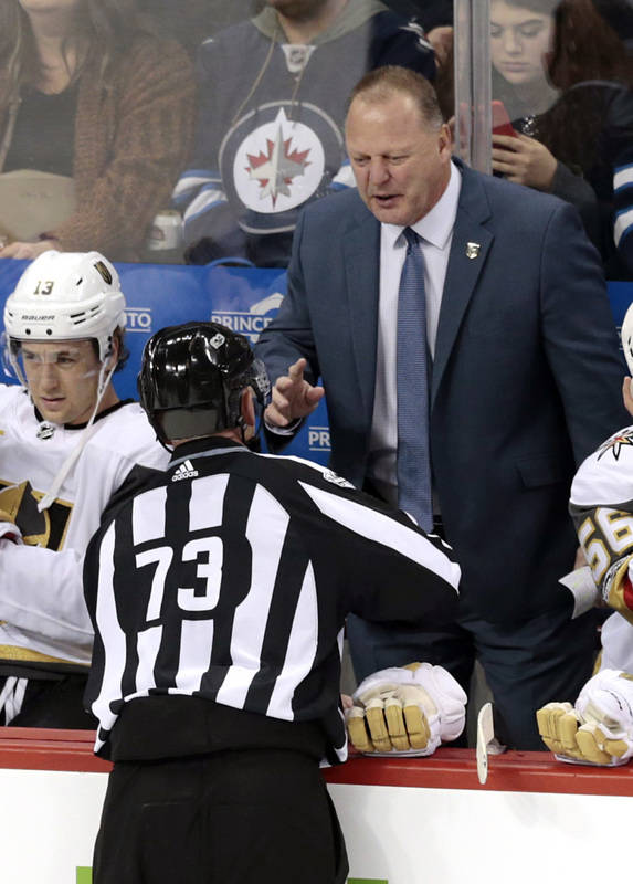 Dec 1, 2017; Winnipeg, Manitoba, CAN; Vegas Golden Knights Head Coach Gerard Gallant talks with Linesman Vaughan Rudy during a stop in play in the first period at Bell MTS Place. (James Carey Lau ...