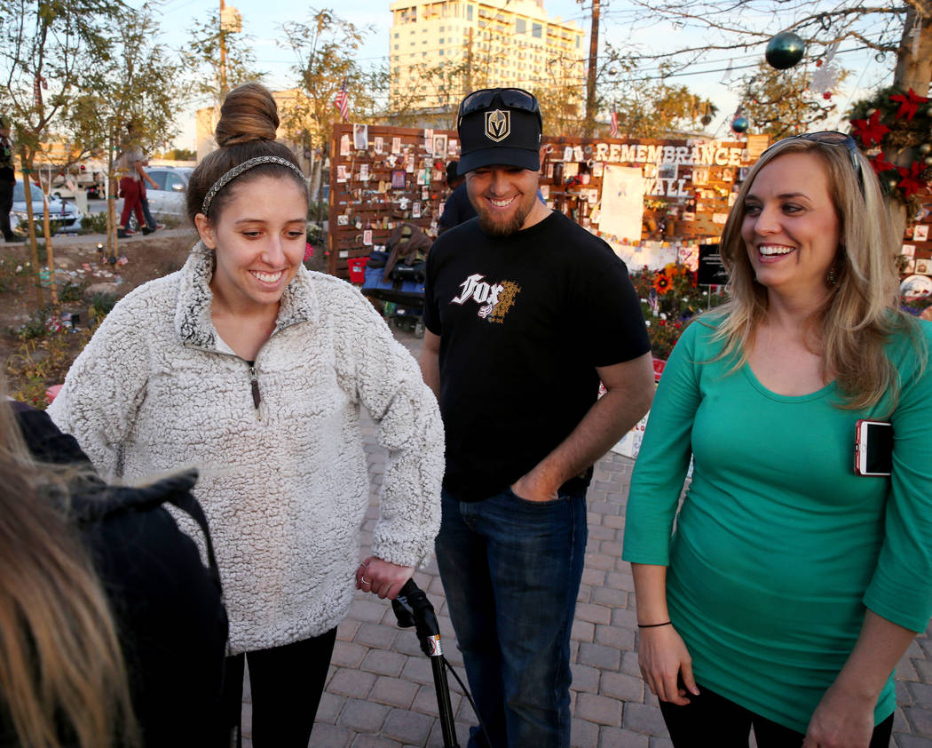 Katrina Hannah, 21, of La Verne, Calif., , left, visits with Austin Stout, of Las Vegas, who carried her to safety after she was shot at the Route 91 Harvest festival and his wife Tara during a vi ...