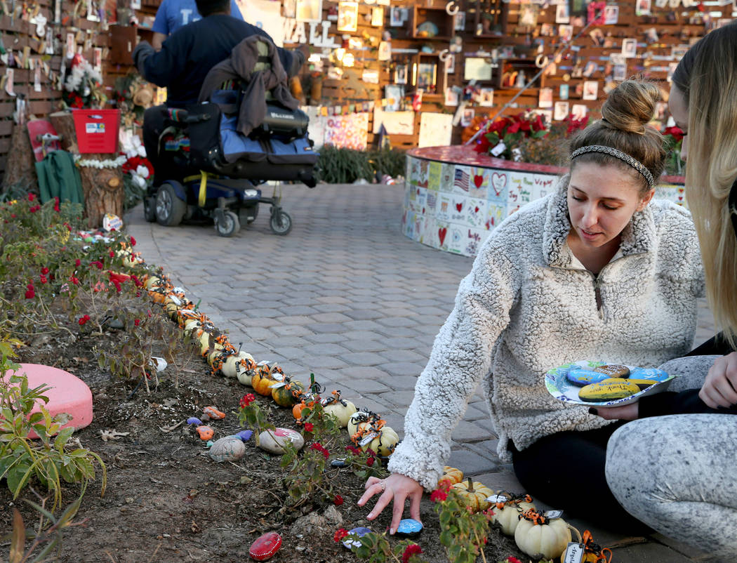 Katrina Hannah, 21, of La Verne, Calif., who was shot at the Route 91 harvest festival country music concert, places rocks during a visit to the Healing Garden in downtown Las Vegas Thursday, Jan. ...