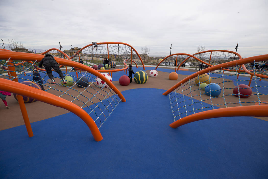 Children play a giant climbing structure known as 'The Orange Beast' at Summerlin's Fox Hill Park in The Paseos village neighborhood, Saturday, Jan. 6, 2018, in Las Vegas. Richard Brian Las Vegas  ...