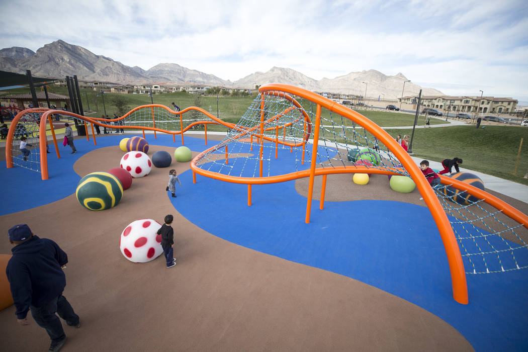 Children play on a giant climbing structure known as 'The Orange Beast' at Summerlin's Fox Hill Park in The Paseos village neighborhood, Saturday, Jan. 6, 2018, in Las Vegas. Richard Brian Las Veg ...