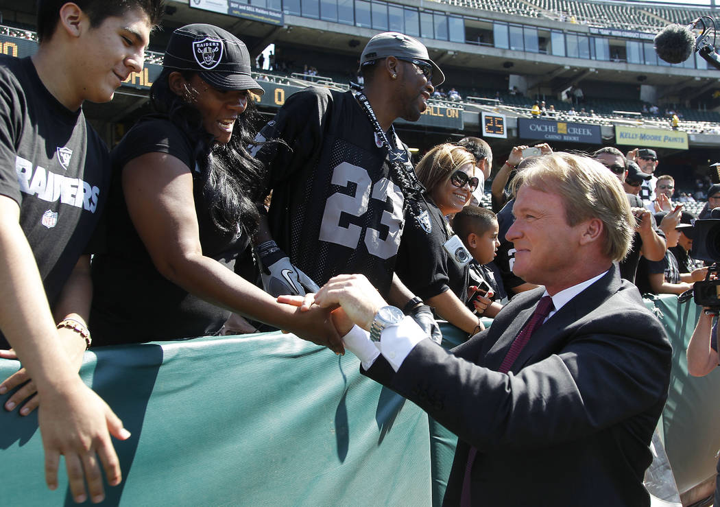 NFL broadcaster and former Oakland Raiders head coach Jon Gruden greets fans before an NFL preseason football game between the Oakland Raiders and the Dallas Cowboys in Oakland, Calif., Monday, Au ...