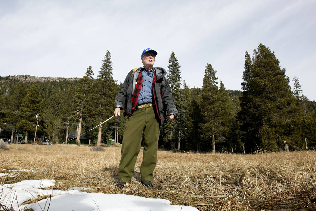 Frank Gehrke, chief of the California Cooperative Snow Surveys Program for the Department of Water Resources, looks over a nearly snow barren meadow while conducting the first snow survey of the s ...