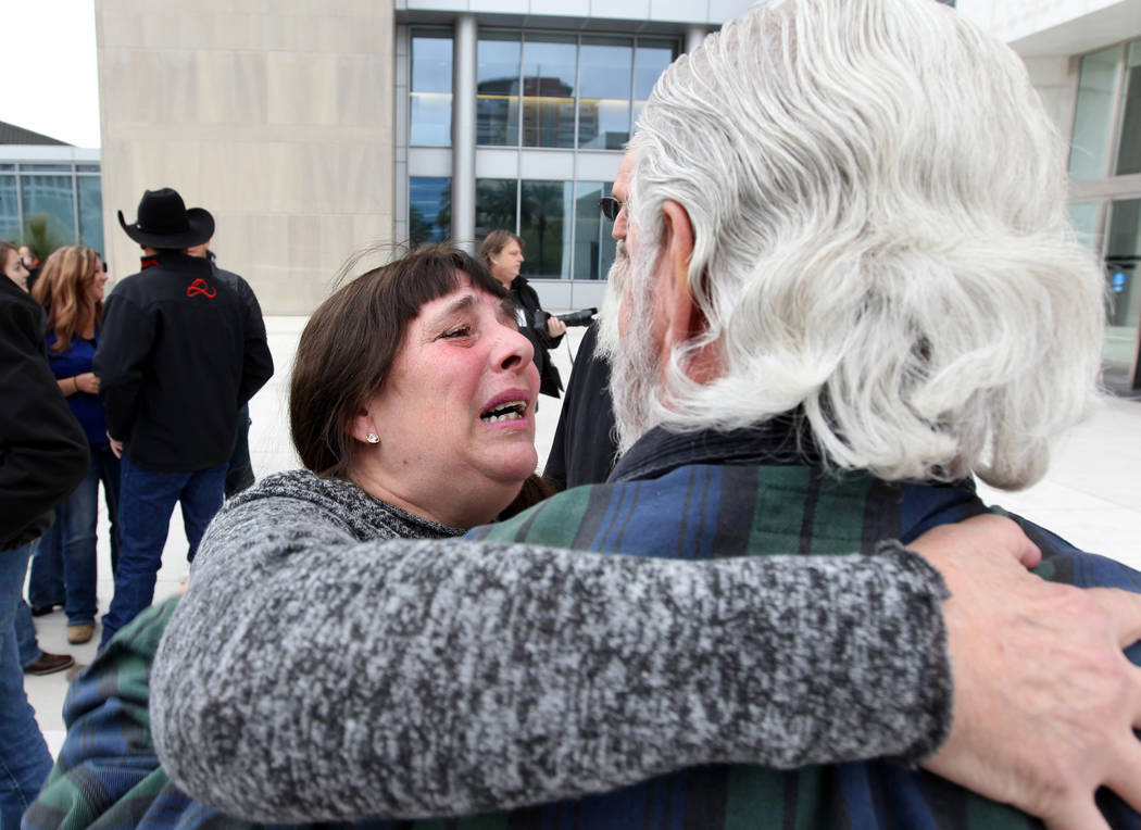 Cliven Bundy supporters Maggie Rose McGrath and Brand Thornton hug outside Lloyd George U.S. Courthouse in Las Vegas Monday, Jan. 8, 2017, after a federal judge dismissed the case with prejudice a ...