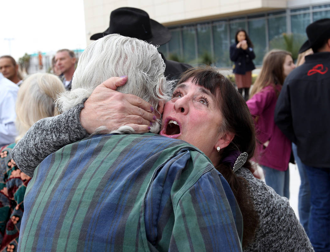 Cliven Bundy supporters Maggie Rose McGrath and Brand Thornton hug outside Lloyd George U.S. Courthouse in Las Vegas Monday, Jan. 8, 2017, after a federal judge dismissed the case with prejudice a ...