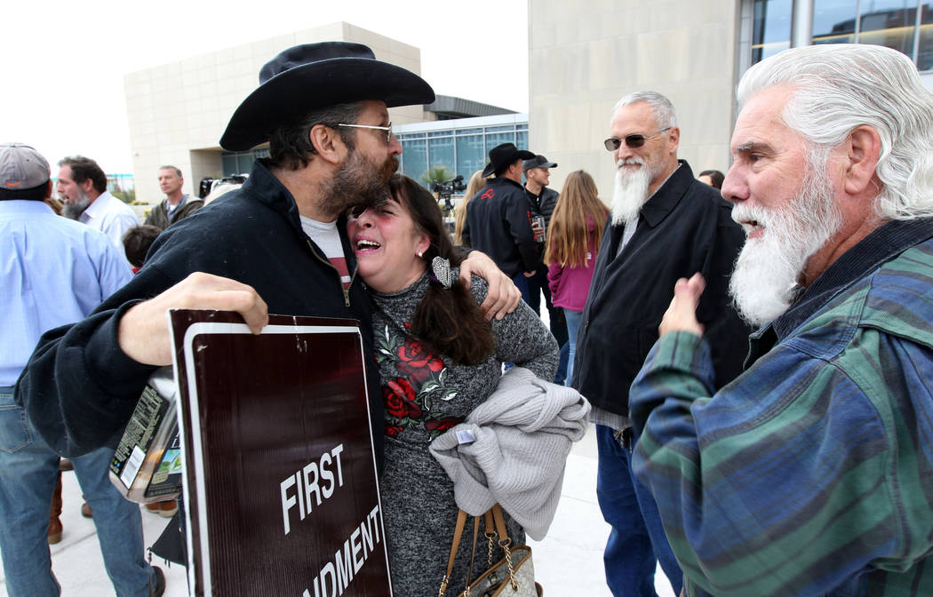 Cliven Bundy supporters Greg Whalen and Maggie Rose McGrath hug outside Lloyd George U.S. Courthouse in Las Vegas Monday, Jan. 8, 2017, after a federal judge dismissed the case with prejudice agai ...