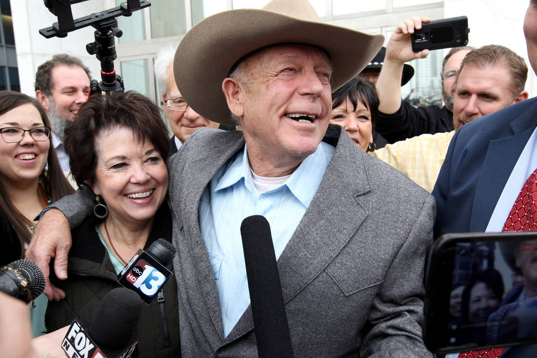 Cliven Bundy hugs his wife, Carol talk to the news media after walking out of Lloyd George U.S. Courthouse in Las Vegas a free man Monday, Jan. 8, 2017, after a federal judge dismissed the case wi ...