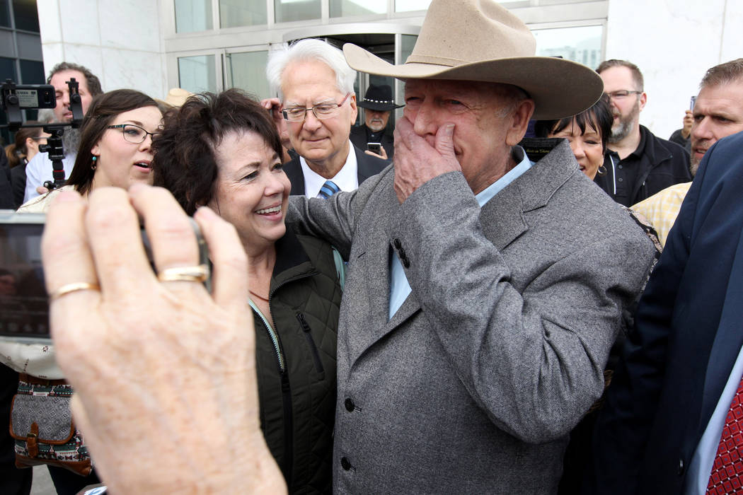Cliven Bundy hugs his wife, Carol talk to the news media after walking out of Lloyd George U.S. Courthouse in Las Vegas a free man Monday, Jan. 8, 2017, after a federal judge dismissed the case wi ...