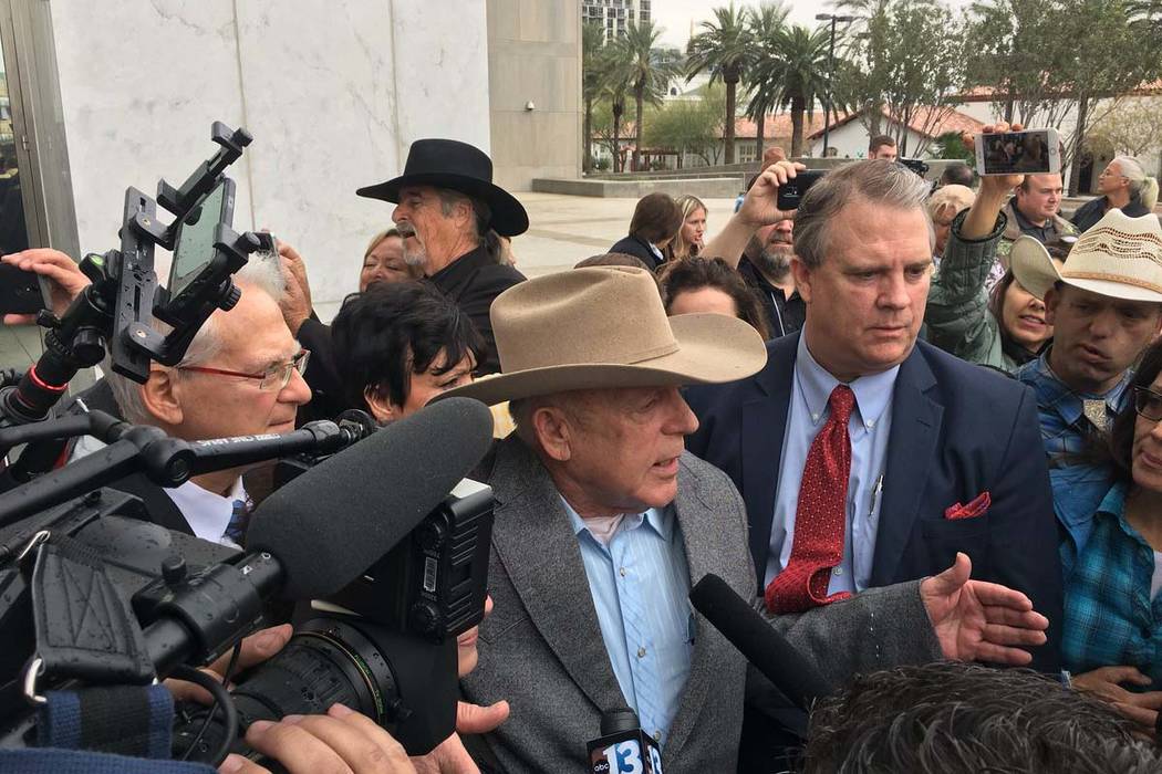 Cliven Bundy walks out of federal courthouse in Las Veas for first time in nearly two years, Monday, Jan. 8, 2018. His son Ryan Bundy is to the far right, in a cowboy hat. (David Ferrara/Las Vegas ...