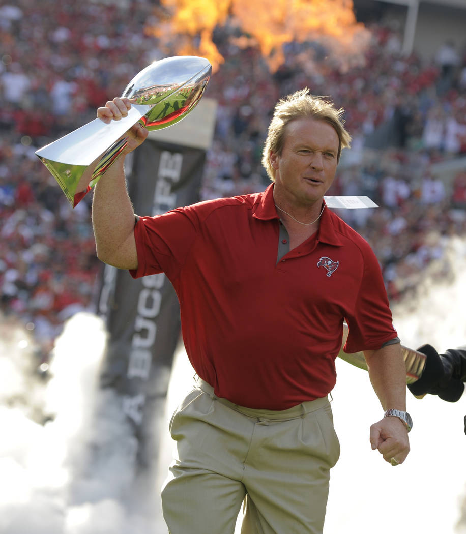 FILE - In this Dec. 9, 2012, file photo, former Tampa Bay Buccaneers and Oakland Raiders head coach Jon Gruden carries a Super Bowl trophy onto the field during halftime of an NFL football game as ...