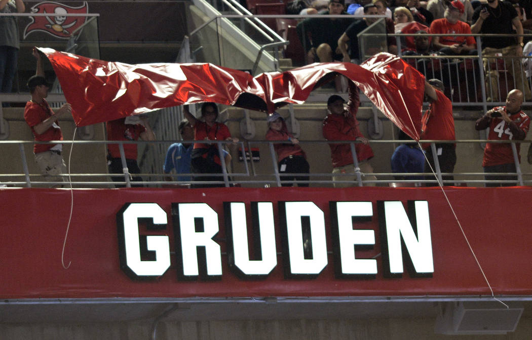 Former Tampa Bay Buccaneers head coach Jon Gruden's name is uncovered after being inducted into the team's Ring of Honor during the halftime of an NFL football game against the Atlanta Falcons Mon ...