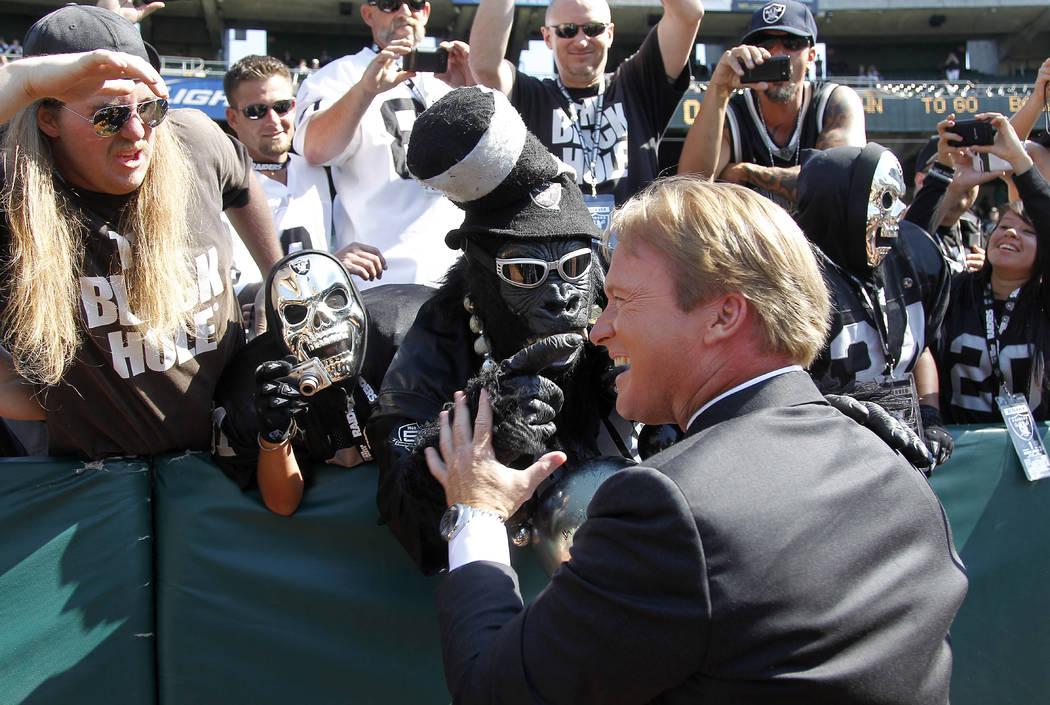 NFL broadcaster and former Oakland Raiders head coach Jon Gruden greets fans before an NFL preseason football game between the Oakland Raiders and the Dallas Cowboys in Oakland, Calif., Monday, Au ...