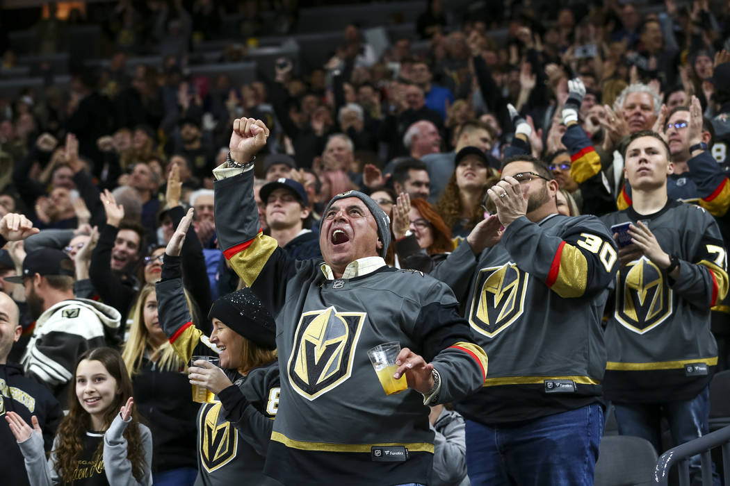 Vegas Golden Knights fans celebrate a goal by Knights defenseman Shea Theodore (27) during the second period of an NHL hockey game between the Vegas Golden Knights and the Nashville Predators at t ...