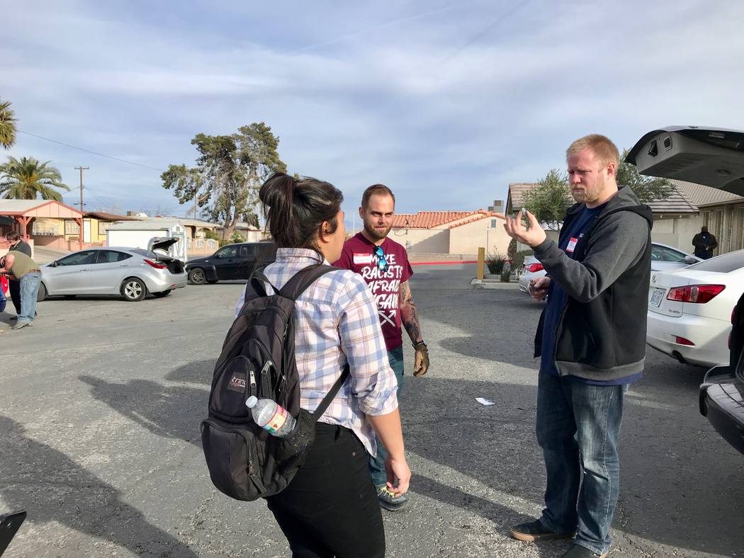 DSA members discuss what type of bulb is needed for a brake light change at the at the Democratic Socialists of America Las Vegas chapter's first brake light change event at First African Methodis ...