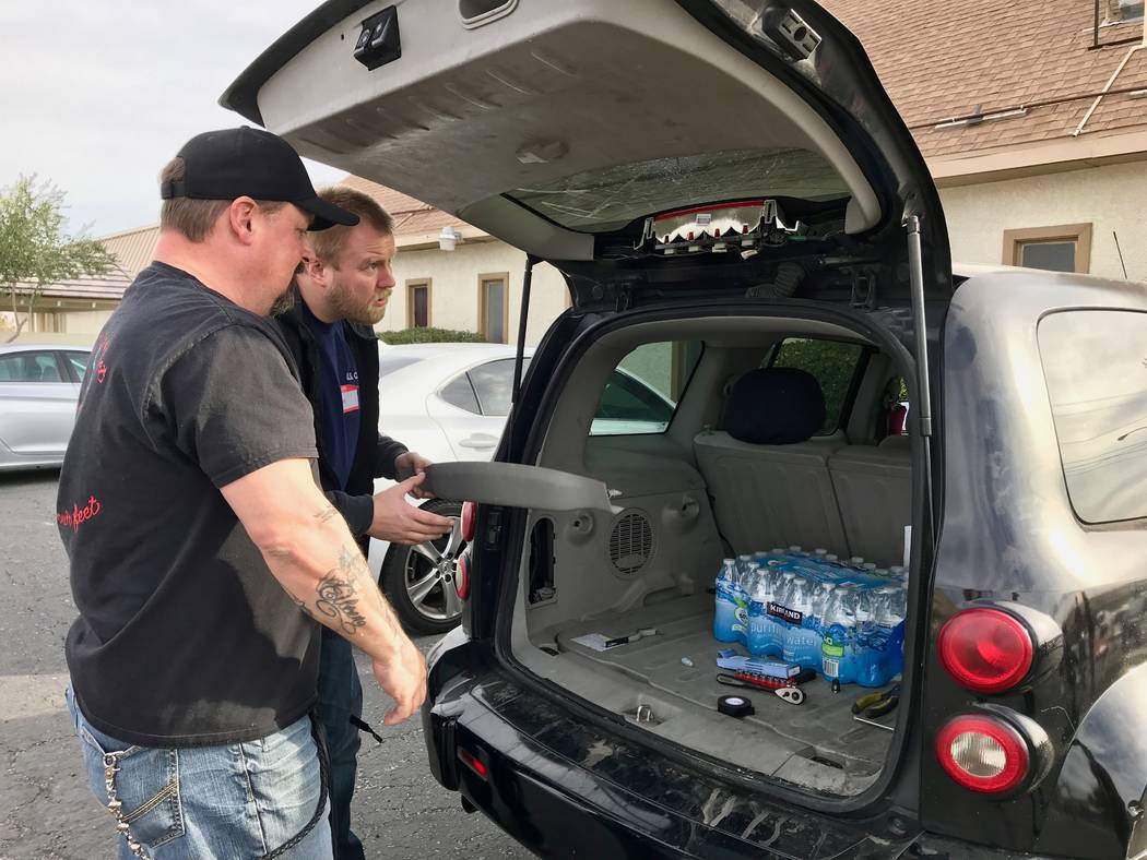 Volunteers change a vehicle brake light at the Democratic Socialists of America Las Vegas chapter's first brake light change event at First African Methodist Episcopal Church in North Las Vegas, J ...