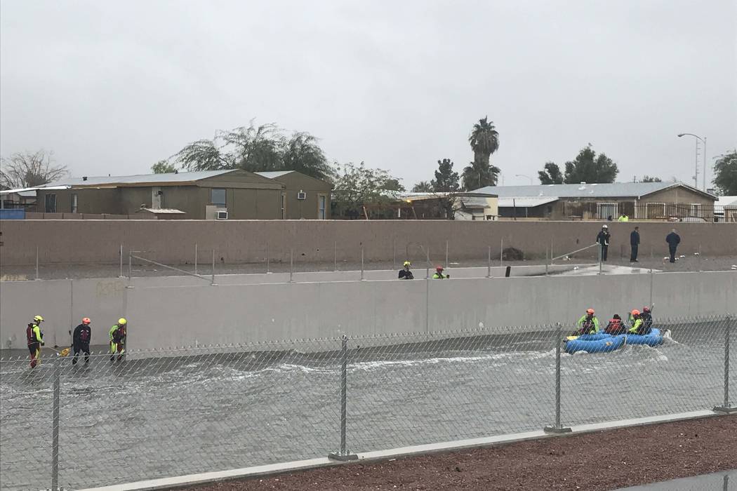 North Las Vegas and Las Vegas fire departments joined forces to rescue two people from a flooded wash near Carey Avenue and Pecos Road, Tuesday, Jan. 9, 2018. (Rachel Crosby/Las Vegas Review-Journal)