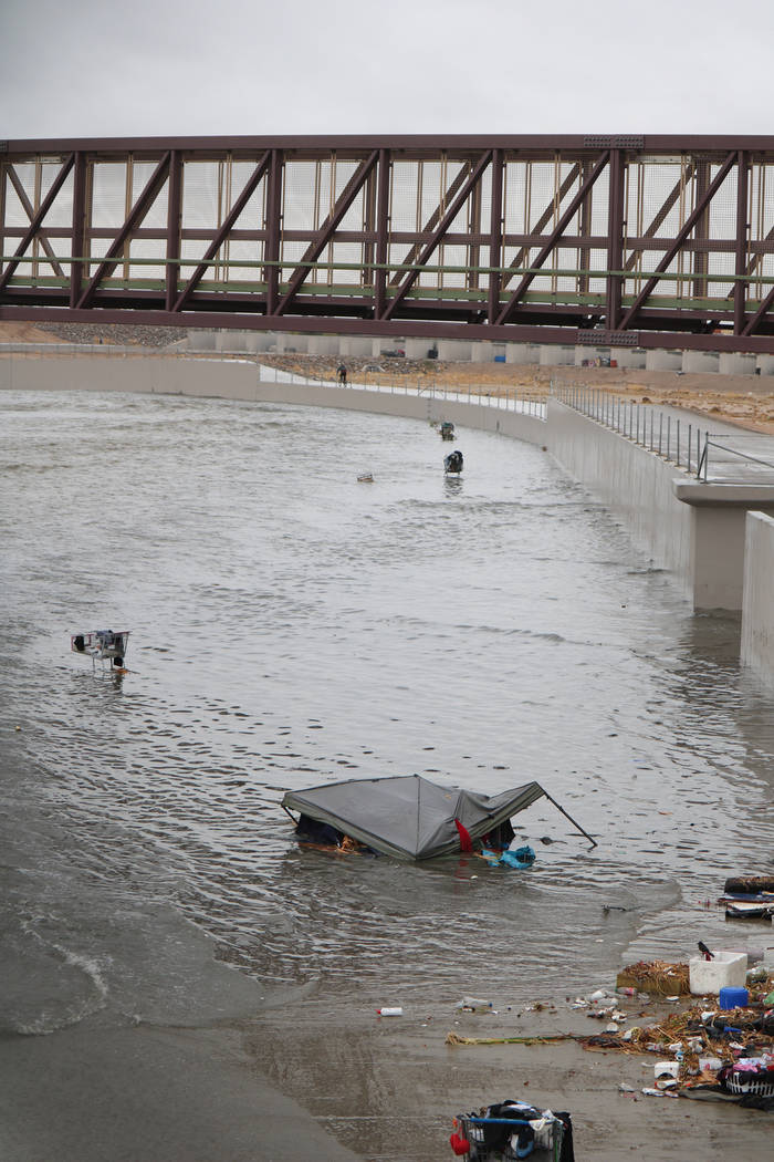 A tent and several shopping carts are caught in floodwaters above a detention basin near east Cheyenne Avenue along the Las Vegas Wash on Tuesday, Jan. 9, 2018. About a mile downstream, rescue cre ...
