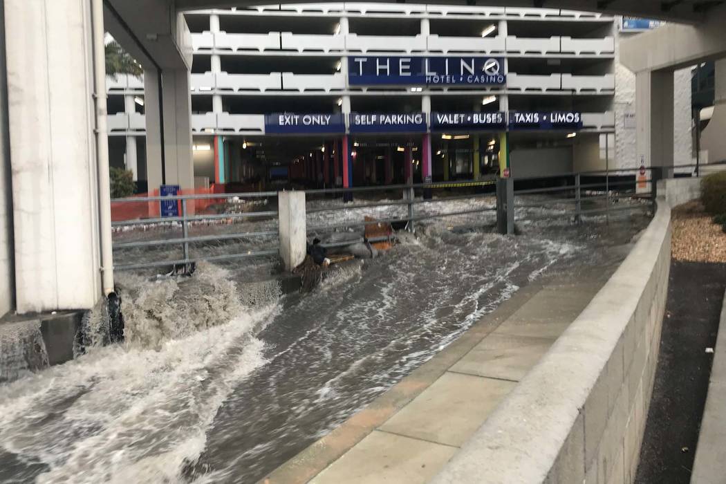Floodwaters flow out of garage of the Linq on the Las Vegas Strip and run into the wash behind the hotel-casino, Tuesday, Jan. 9, 2018. (Elaine Wilson/Las Vegas Review-Journal)