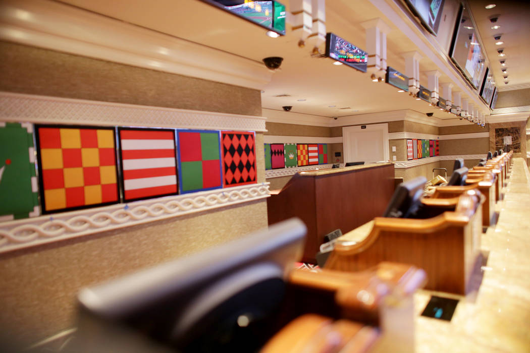 The betting desks at the new race and sports book at the Wynn on Monday, July 31, 2017, in Las Vegas. Behind the counter are new high chromatic jockey silks. There are new screens, seats and carpe ...