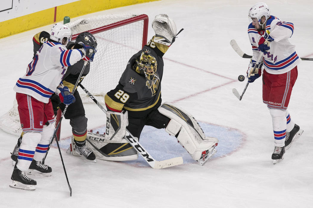 Vegas Golden Knights goaltender Marc-Andre Fleury (29) deflects a shot on goal during the second period of an NHL hockey game between the Vegas Golden Knights and the New York Rangers at the T-Mob ...