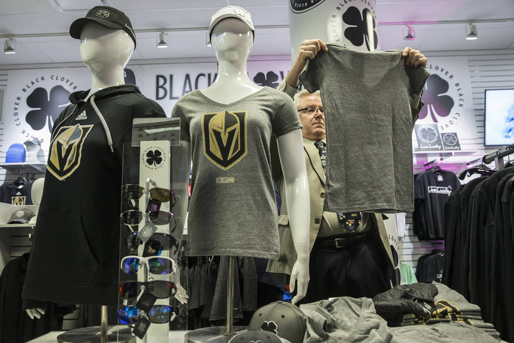 Fans purchase official Golden Knights merchandise at the conclusion of a ceremony to unveil the Las Vegas' NHL expansion franchise's official team nickname, logos and colors on Tuesday, Nov. 22, 2 ...