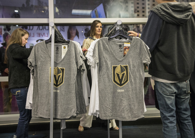 Fans purchase official Golden Knights merchandise at the conclusion of a ceremony to unveil the Las Vegas' NHL expansion franchise's official team nickname, logos and colors on Tuesday, Nov. 22, 2 ...